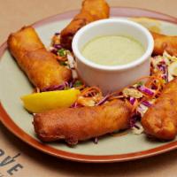 Hush Puppy Fish & Chips · Five pieces of Icelandic Cod battered and golden fried. Served over a bed of slaw-mixture of...