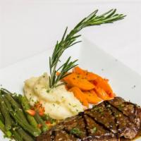 Bife Á Madeira · New York strip a certified Angus beef with crushed peppercorns, in Madeira wine sauce, serve...