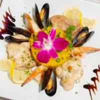 Tamboril (Monkfish) Á Lusitano · Roasted monkfish with shrimp and mussels in saffron sauce served with rice.