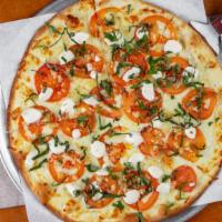 Margerita Pizza · Fresh roma tomato, basil, buffalo mozzarella in olive oil and fresh garlic sauce.