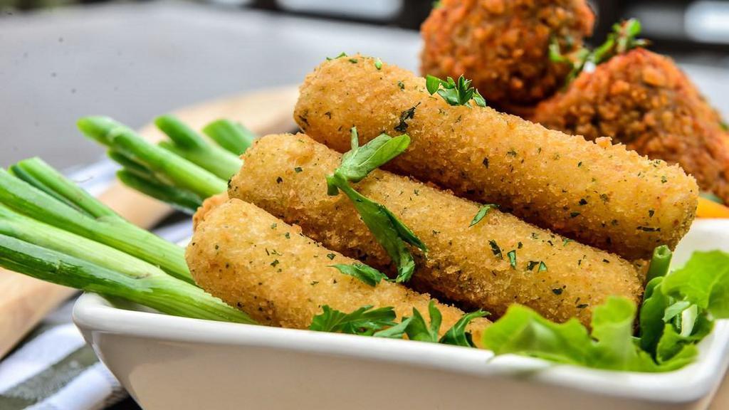 Mozzarella Sticks · 6 Golden Fried Mozzarella Sticks dusted with Parmesan Cheese served with Marinara Dipping Sauce.