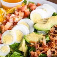 Cobb Salad · Romaine Lettuce topped with Shredded Cheddar Cheese, Sliced Avocado, Bacon Bits, Chopped Boi...