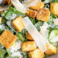 Caesar Salad · Romaine Lettuce Topped with Croutons and shaved Parmesan Cheese. Caesar dressing on the side.