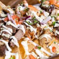 Loaded Nachos · Corn Tortilla Chips Layered with Queso Cheese. Served with  Pico De Gallo, Black Beans, Sour...