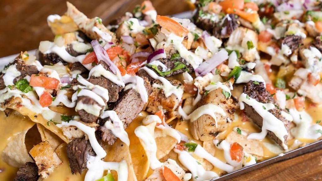 Loaded Nachos · Corn Tortilla Chips Layered with Queso Cheese. Served with  Pico De Gallo, Black Beans, Sour Cream and your choice of Lobster, Shrimp Grilled or Fried, Chicken Grilled or Fried, Ground Beef, Fajita Beef.