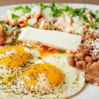 Chilaquiles Con Huevo · Soft fried corn tortillas simmered in red or green salsa topped with cheese, sour cream, two...