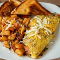 Farmhouse Omelet · Ham, sausage, peppers, bacon, onions, and Cheddar cheese.