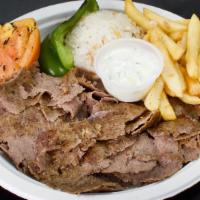 Lamb (Yaprak) Doner With Rice · Thinly sliced lamb (Yaprak) doner with rice, greens, grilled tomatoes and peppers.