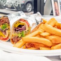 Adana Kebab Wrap · Large size skewer of grilled chopped lamb in 12” tortilla w/ special tomato sauce, sliced on...
