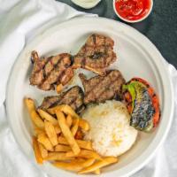 Lamb Chops · 5 pieces of lamb chops cooked over char-grill. Served with rice,  greens, grilled tomato and...