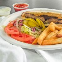 Adana Kebab Sandwich · Large size skewer of grilled chopped lamb in sandwich bread w/ sliced onions, greens, pickle...