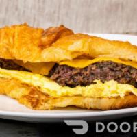 Sausage, Egg And Cheese Croissant · A scrambled egg base, a chicken or beef sausage patty, and melted cheddar cheese all sandwic...