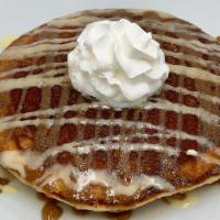 Cinnamon Roll Pancakes  · Two Cinnamon roll inspired Pancakes centered with our cream cheese filling. Drizzled with ci...
