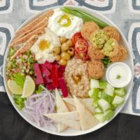 Monster Mezzah Plate · Dolmas, falafel, feta cheese, olives, ajvar, salad, and tzatziki. Serves two people.