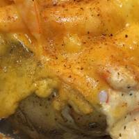 Seafood Stuffed Potato · Potato smothered with crab dip, shrimp and cheddar cheese topped with old bay.