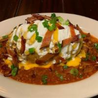 Baked Idaho Potato Plate · A giant Idaho potato smothered in butter, sour cream, fresh chives, and melted cheddar.