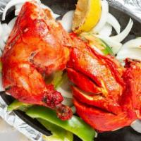 Tandoori Chicken · Chicken marinated in yogurt, spices, herbs, and barbecued in the tandoor.