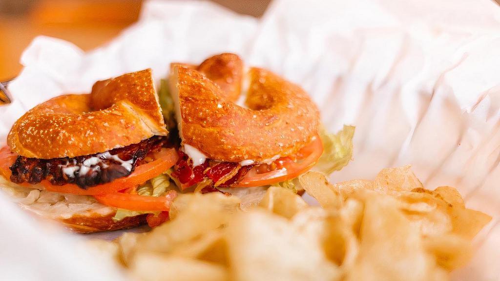 Blt Pretzel Sandwich · Bacon, lettuce, tomato and choice of pesto, garlic or chipotle aioli on a salted pretzel bun with kettle chips.