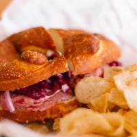 Roast Beef Pretzel Sandwich · Sliced roast beef, shaved red onion, red cabbage slaw and garlic aioli served on a salted pr...