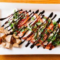 Caprese Salad · Fresh sliced mozzarella, sliced tomatoes, basil leaves, and pretzel croutons drizzled with a...