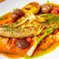Baja Striped Bass · Cherry tomato and fennel ragout, confit pee-wee potatoes, salsa verde, and crispy parsnips.