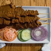 Beef Stick Suya · Thin sliced grilled beef marinated with authentic Nigerian seasonings, with a garnish of yaj...