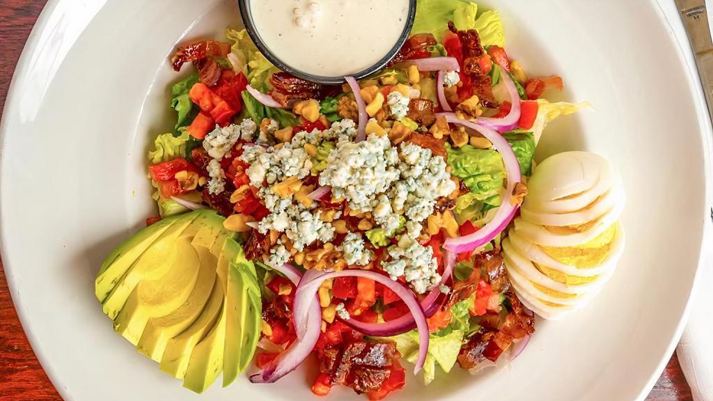 Wedge Vs. Cobb · Iceberg, romaine, red onion, Roma tomato, avocado, walnuts, candied bacon, Bleu cheese crumbles, hard-boiled egg, house-made Bleu cheese dressing.