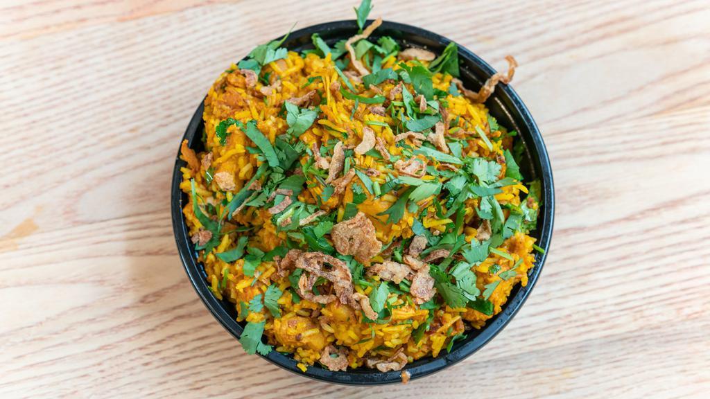 Chicken Biryani · Basmati rice and chicken sautéed in a spicy blend of onion, garlic, ginger, turmeric, cumin and tomatoes