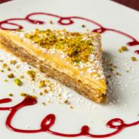 Baklava · Paper thin layers of honey-soaked pastry and walnuts, topped with cardamom and pistachios.