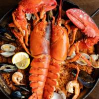Paella De Langosta · Whole Maine lobster, shrimp, squid, clams, and mussels. Delivered with the paella pan. Made ...