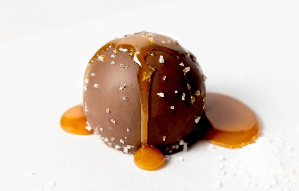 Salted Caramel Truffle · Creamy salted caramel flavored milk chocolate in a milk chocolate shell topped with sea salt.