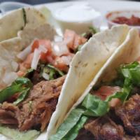 Pork Tacos · Three tacos made with pulled taco pork seasoned and topped with lettuce, tomatoes, onions an...