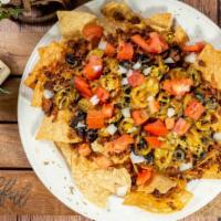 Nachos Grande · Topped with choice of meat, diced tomatoes, jalapeños, black olives and melted cheese. Serve...