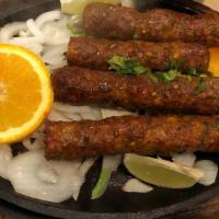 Lamb Seekh Kebab · Tender rolls of succulent minced lamb, mixed with ginger, green chilies, spices, and cumin s...