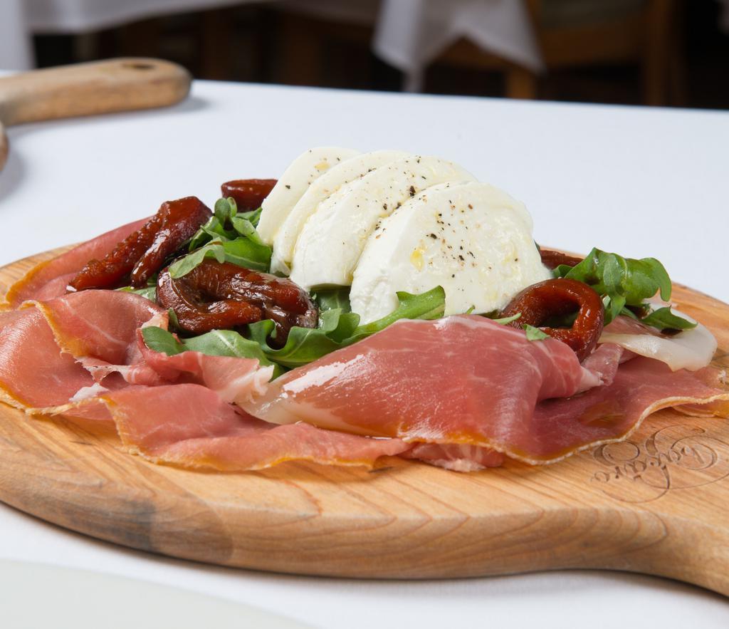 Italian Buffalo Mozzarella & Prosciutto Di Parma · Buffalo mozzarella on a bed of Prosciutto di Parma with fire-roasted red bell peppers, rocket, aged balsamic and Tuscan olive oil.