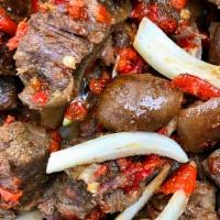 Asun  · Spicy Goat meat chunks cooked in spicy sauce garnished with onions.