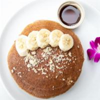 Protein Pancakes · Plant based. Gluten free. Almond flour, chia seeds, hemp seeds, topped with banana and macad...