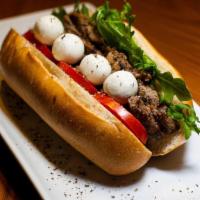 Goatta Have It · Hoagie bread filled with arugula, tomatoes, grilled Angus beef and Natural Goat Cheese, acco...