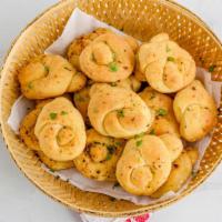 Garlic Knots · Fresh dough knots. Oven-baked and glazed with garlic sauce and a special Garlic Romano seaso...