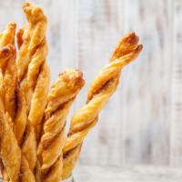Cinnamon Sticks · Warm and satisfying dessert bread sticks. Coated with cinnamon sugar and served with a dippi...
