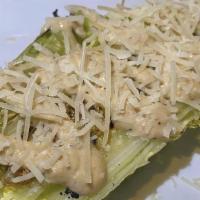 Grilled Caesar Salad · Heart of Romaine, Caesar Dressing, Parmesan Cheese.