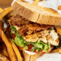 Wholly Club · Marinated chicken breast sliced thin, stacked with bacon, tomatoes, lettuce, and mayo on Who...