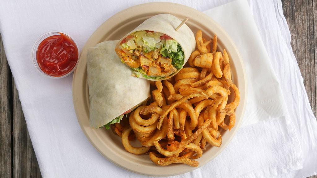 Buffalo Chick'N Wrap · Vegan chick'n, lettuce, tomato, pickles, buffalo sauce, house ranch, and cheddar cheeze. Fries included.
