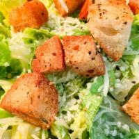 Caesar Salad · Fresh Romaine lettuce with homemade caesar dressing, croutons, and shaved Parmesan cheese.