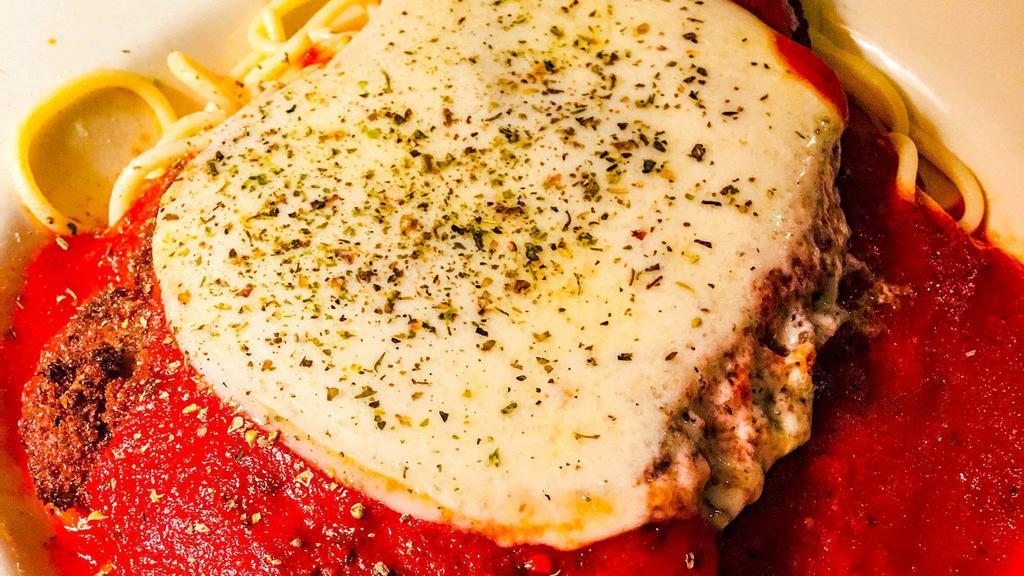 Chicken Parmesan Over Pasta · Thinly pounded chicken breast that is breaded with Italian bread crumbs. Stove top fried and then baked with a slice of provolone over the top of the fillet. Chicken fillet is served over spaghetti or Penne. Comes with an Italian Roll