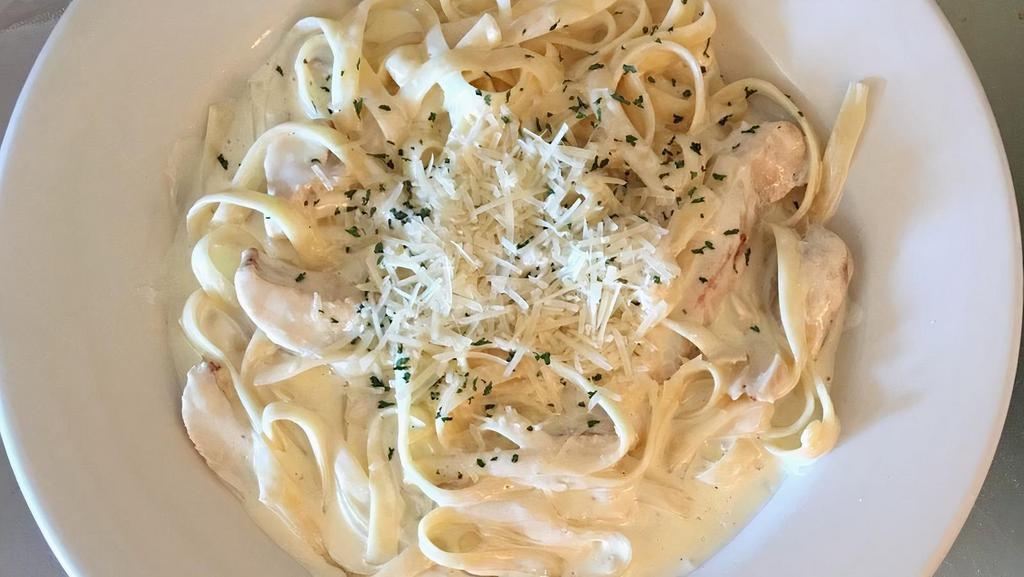 Fettuccine Alfredo · Fettuccini noodles with Alfredo sauce that contains organic cream, grated pecorino cheese, and topped with shredded parmesan & parsley.