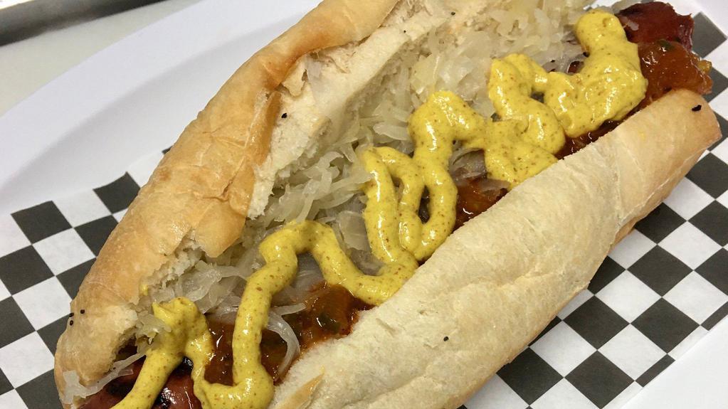 New York Dog · A grilled 1/4 lb all-beef hot dog topped with spicy brown mustard, sauerkraut, and onion sauce. Comes with Chips and a Pickle.