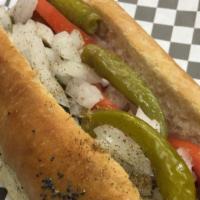 Chicago Dog · A grilled 1/4 all-beef hot dog topped with a pickle spear, sliced tomato, chopped onion, swe...