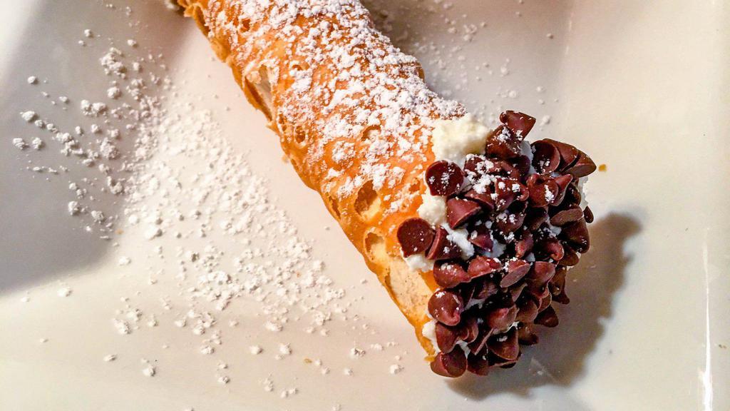 Cannoli · Cannoli filling contains ricotta cheese, vanilla, and powdered sugar. Cannoli shell is filled and then each end is dipped in small chocolate chips. Topped with powdered sugar.