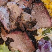 Jerk Pork Salad · Place the best jerk pork on top of our fresh salad. Add your toppings and enjoy!